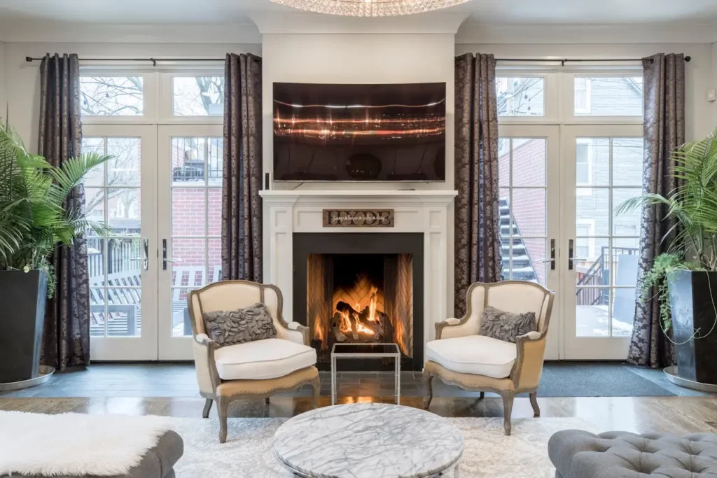 A cozy living room with a roaring fireplace in the winter