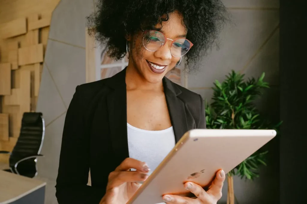 A realtor using a CRM platform on a tablet.