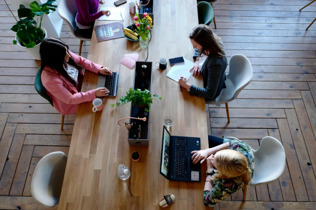 A team of realtors reviewing CRM analytics on a laptop.