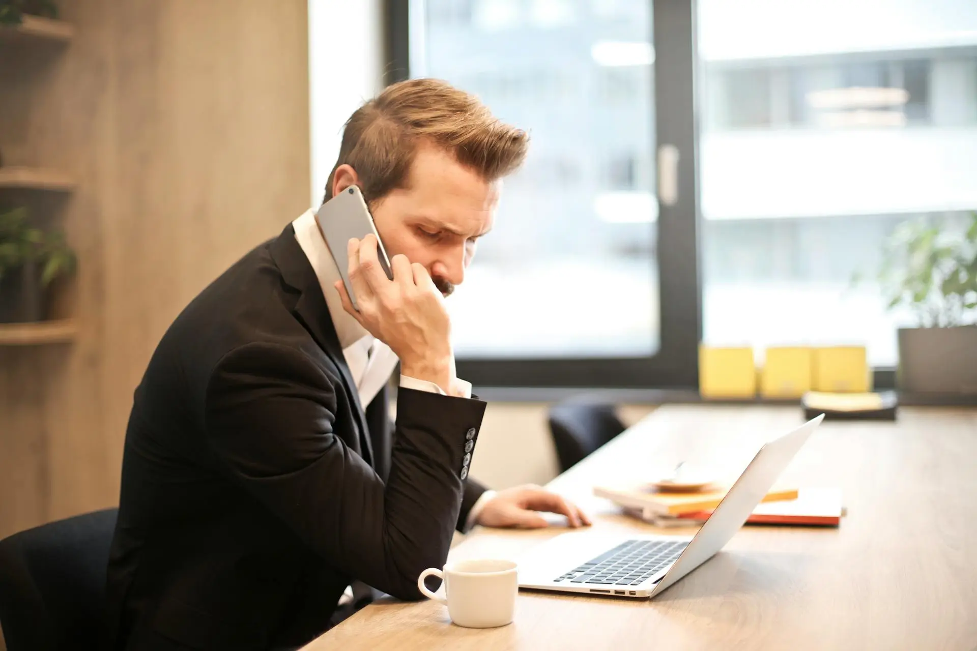 A real estate agent receiving a client referral over the phone