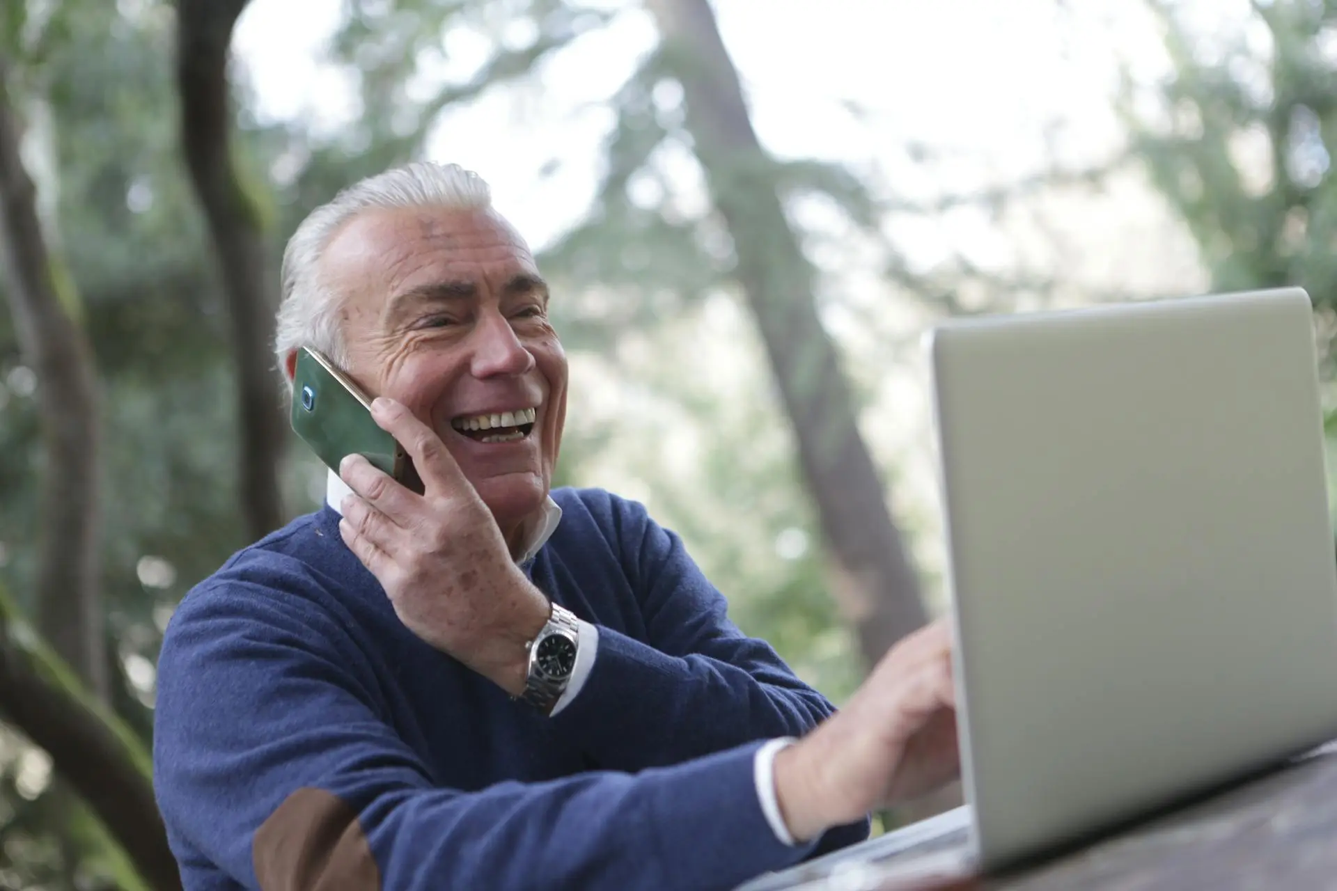 A real estate agent scheduling social media content on a laptop