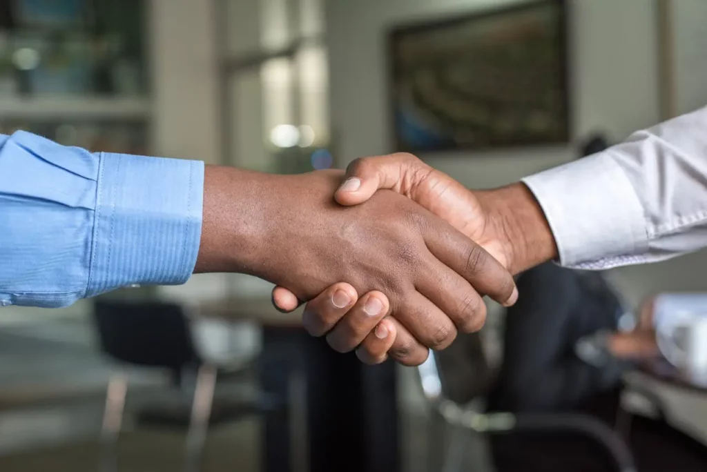 A successful real estate agent closing a deal after refining their marketing strategy.